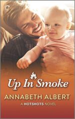 Up in Smoke by Annabeth Albert. A very orange cover! A smile, scruffy man is holding a baby. There is an image of a flame in the title and it looks like the baby is reaching toward it.