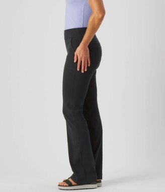 A side view of a model in black yoga pants and sandals with a light blue top. You can see the pocket on the front and the back. REAL POCKETS 