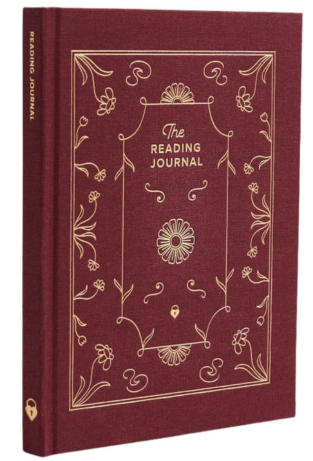 A red hardcover book with gold scrollwork on the front and The Reading Journal above a daisy image in the middle