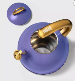 a purple enamel kettle with gold hardware. On the handle it says HELLO THERE. 