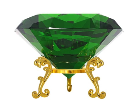 A close up of a large green crystal cut into a diamond shape on a gold stand with filigree legs