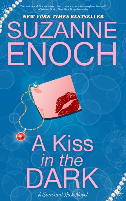 A Kiss in the Dark by Suzanne Enoch A blue background of bubble images with a postit with a red lipstick kiss and a ruby necklace 