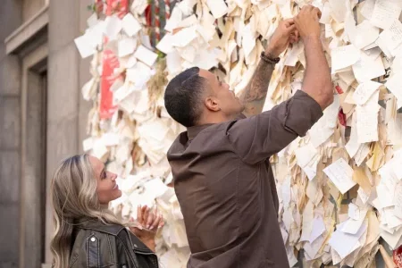 Dina and Grant post their wishes on the wall