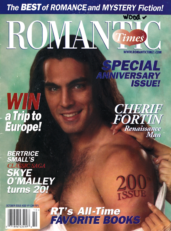 Romantic Times 200th issue featuring model Cherif Fortin facing the side while hands are pulling his shirt from his shoulder. On this tricep is a tattoo that says 200th issue