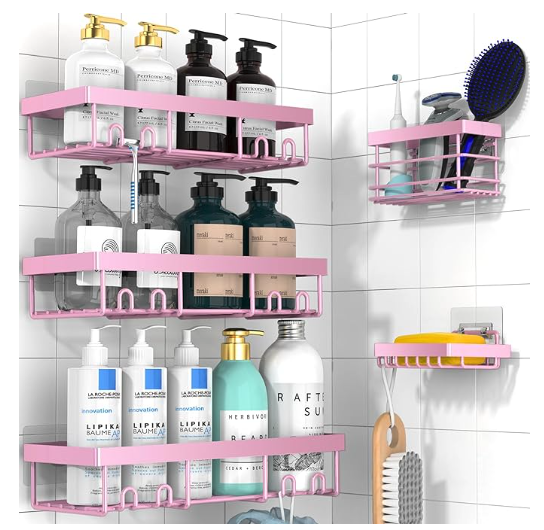 A set of pink racks hold multiple beauty products in racks of three sizes, a small one for soap, a medium one for smaller tools, and large ones for bottles of stuff. 