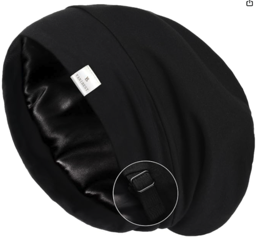 a black fabric beanie with an adjustable slider for the elastic, with satin on the inside 