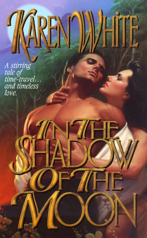 John DeSalvo arching his back, shirtless wearing pants, into the arms of a woman with dark hair who has one hand on his jugular and one hand below his pec.