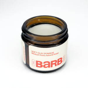 Barb hair pomade, a cream pomade in a brown glass jar with a logo that says The Barb Shop