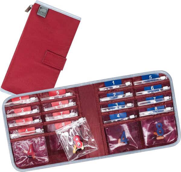 A red folding pill case with eight sections with little bags for day and night