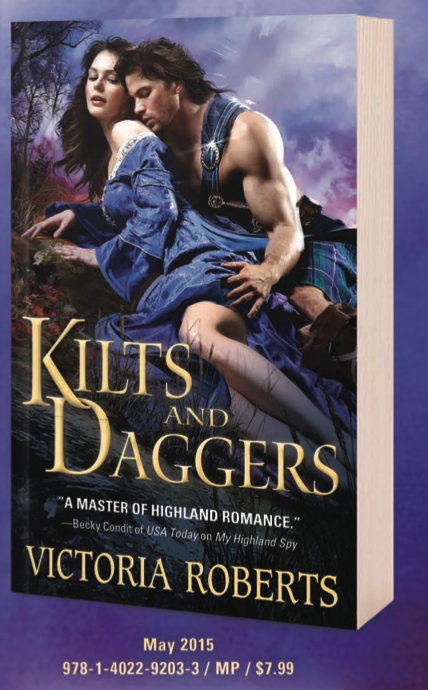 Kilts and Daggers by Victoria Roberts. A white muscly guy is wearing a green and blue kilt with a length over one bare shoulder because of COURSE he doesnt' have a shirt on. He is leaning on a steep hill on a rock behind a white woman with blck hair and an off the shoulder gown that honestly looks like denim. He is positioned directly behind her like they're doing the butt secks. 