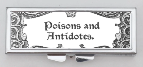 A silver rectangular box case with filigree and the words POISONS and ANTIDOTES in old English script 