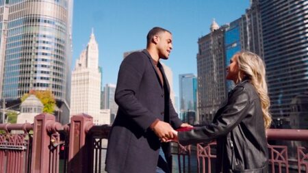 Dina and Grant stand on a bridge