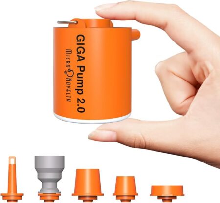 An orange miniature air pump being held between a thumb and forefinger. There are five nozzle adapters shown at the bottom in orange and grey