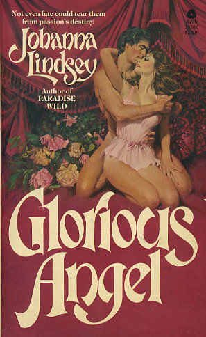 Glorious Angel - a dakr haired white woman in a pink teddy kneels between the knees of a naked dark haired man 