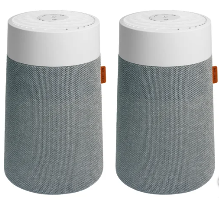 Two cylindrical air purifiers, mostly grey fabric with a white top