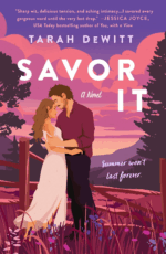 Savor It by Tarah DeWitt. An illustrated cover with a pink, purple, and deep red color palette. A man and woman stand close together in a field with a broken fence behind them. The man has brown hair, a deep red shirt, and black pants. The woman has light brown hair and is wearing a sleeveless, floor length, light blush pink dress. The sky is purple with pink clouds and tall trees peek out from the edges.