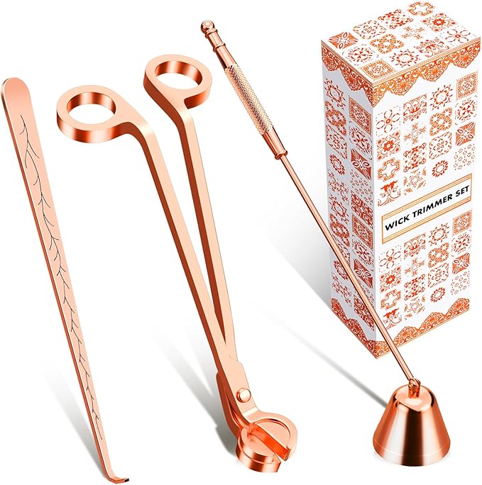 A set of rose gold candle tools: tweezers, candle snuffer, and wick trimmer,