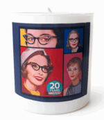 A white jar candle with the SBTB logo of the four 50s ladies with a 20th anniversary insignia on the bottom front