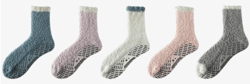 A set of five fuzzy socks with grippy bottoms in five colors, grey, purple, white, pink and grey