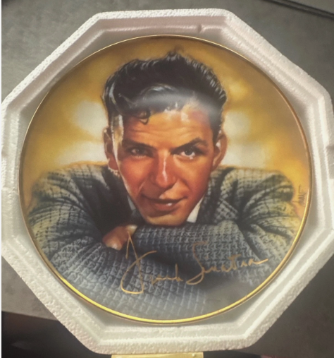 Frank Sinatra collector plate with a picture of young frankie in a checked blazer sitting with his arms folded and chin resting on his folded arms 