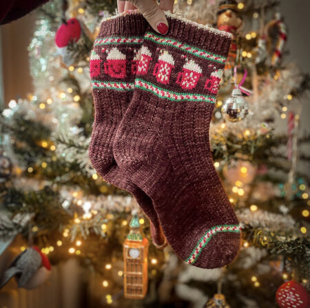 A pair of brown socks with red mugs of cocoa on them