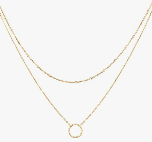 Two thin gold chains, one shorter than the other, with the lower chain attached to a circle pendant