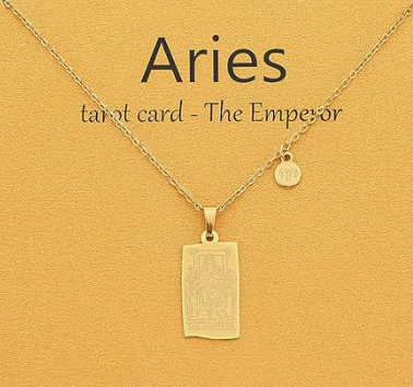 A card that reads ARIES Tarot card - the emporer with a thin gold chain holding a rectangular miniature tarot card, and about an inch from the pendant is a second tiny charm of the aries symbol
