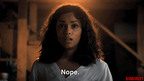 A young African american woman looks at the camera in close up and says "nope"