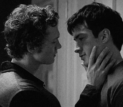 black and white image of ilya with his hand on Shane's face, leaning in to kiss him