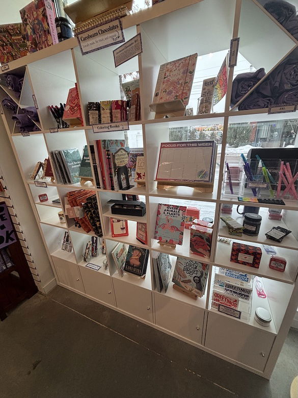 Interior shelves inside Tropes and Trifles with chocolates, cards, games, coloring books and stickers