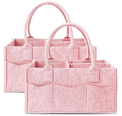Two pink felt caddies with straps, pockets and compartments standing side by side 