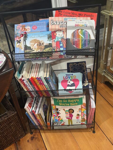 A display cart of childrens books, coloring books, and novels of young readers