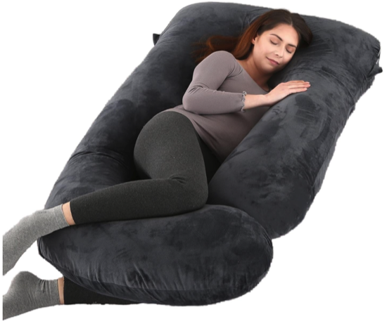 A long dark grey prengnacy pillow that wraps around the person with an L-shaped arm on one side with the short part of the L meant for the knees 