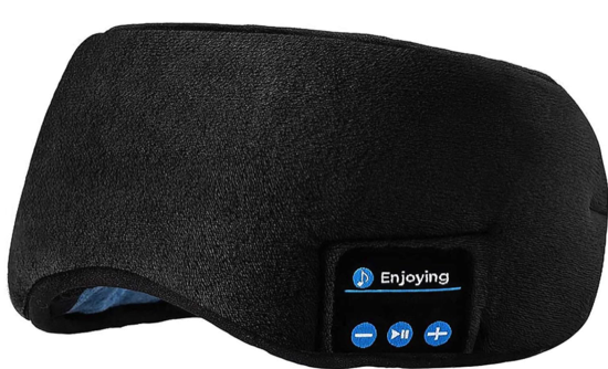 A dark grey fuzzy sleep mask with a bluetooth controller on the lower left edge 