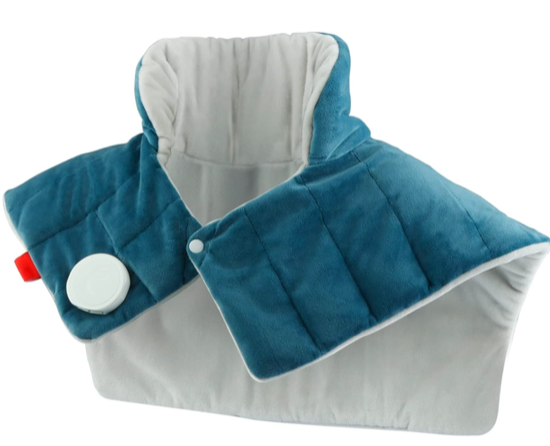 A blue and grey shoulder heating pad with a tall collar in the back that wraps around the shoulders with a snap in the front