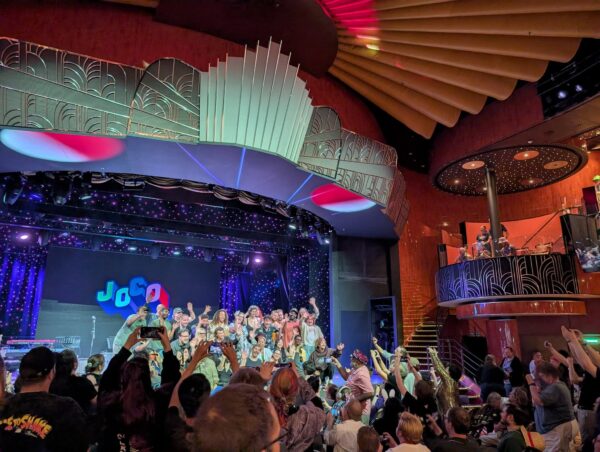 crowd of happy people poses for photo on stage