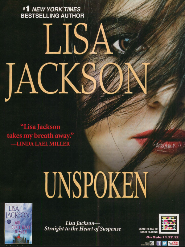 An ad for Lisa Jackson's Unspoken, showing a white woman with dark hair blown over her face so her features are peeking out. Also she has extremely heavy shadow eye makeup perfect for the time. 