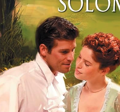 A close up of the couple, where the male model looks a LOT like Jonathan Bailey from Bridgerton 