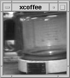  a grey scale low res image of an empty coffee pot on its heated base. Around it is a 90s browser frame also grey and black. 