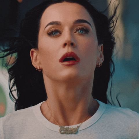 A close up of Katy Perry with electric shocks running through her. she looks orgasmic