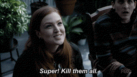 A woman with red hair from the show Gotham smiles and says super! Kill them all.