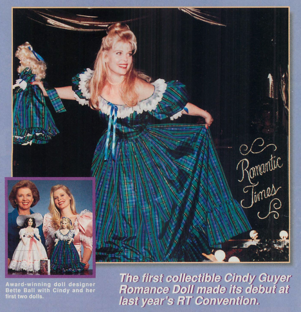 Cindy Guyer is curtseying in a green blue and yellow plaid dress with a wide lace-trimmed neck, and in her hand is one of the dolls designed to match her in the same dress. Behind her is a gold lettered sign that says Romantic Times. 