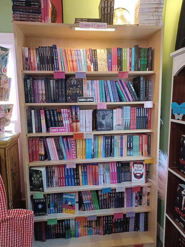 A bookcase labeled signed copies -and there are many. seven shelves worth. 