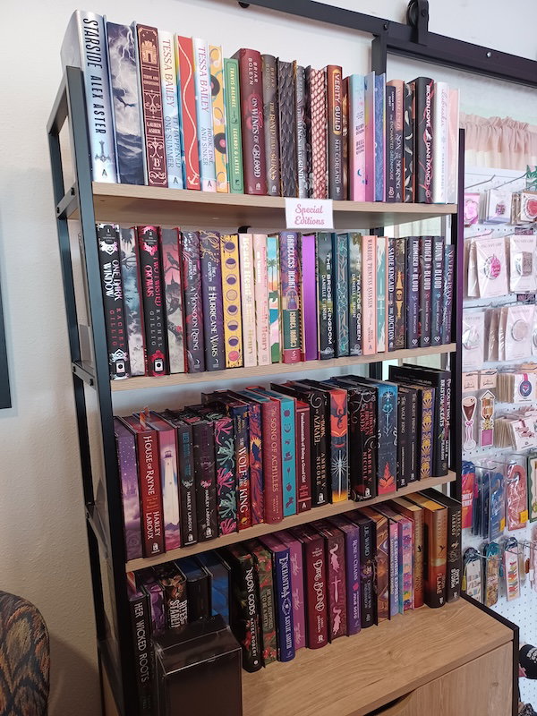  A bookshelf with special editions, some turned spine-out, and some with the sprayed edges facing out