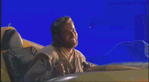 Ewan McGregor grooving out and dancing while flying a spacecraft against a blue screen background
