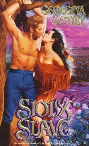 Georgina Gentry's Sioux Savage (oy) featuring a woman with long hair with feathers in it wearing an off the shoulder fringe leather dress. she is close to kissing a man who is shirtless, wearing high-waisted blue trousers, and his hands are tied over a tree branch because she tied him up. Nice