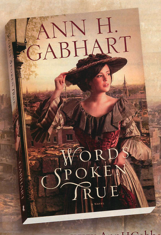 HAT WATCH: Words Spoken True by Ann. H. Gabheart, another Revell (they’re inspirational romance) title. This features a brunette woman in a red and silver gown with a large ruffle at the neck, and ruffled lined bell sleeves. She is wearing a read hat wrapped in red fabric with flowers on top and the whole thing is gorgeous. 