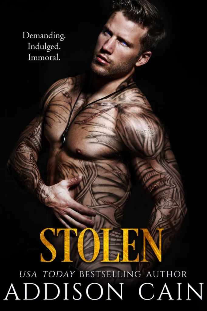 Stolen by Addison Cain. A man with black linework tattoos all over his body. He's twisting at the torso and grabbing his side.