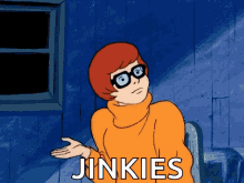 Velma from Scooby Doo saying JINKIES while raising one hand