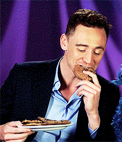 Tom Hiddleston eating a cookie